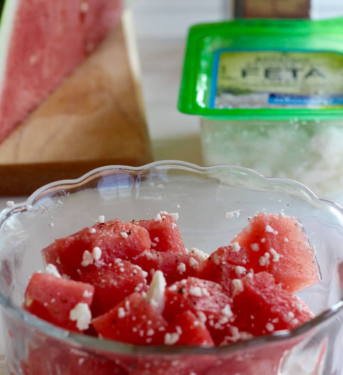 ripe watermelon chunks with feta crumbles and ground black pepper.