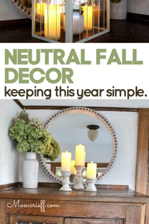 fall decor including candles, hydrangeas and cream colored vase, candleholders and round mirror frame