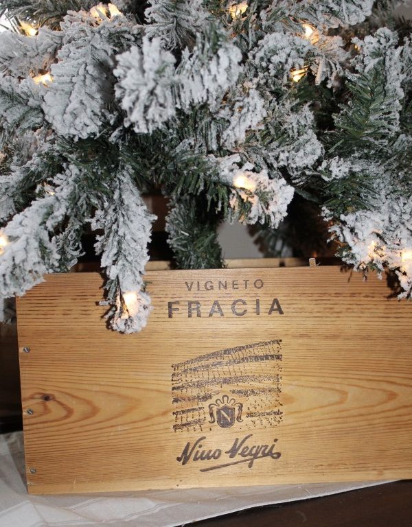 closeup of wooden wine box with a Christmas tree in it.