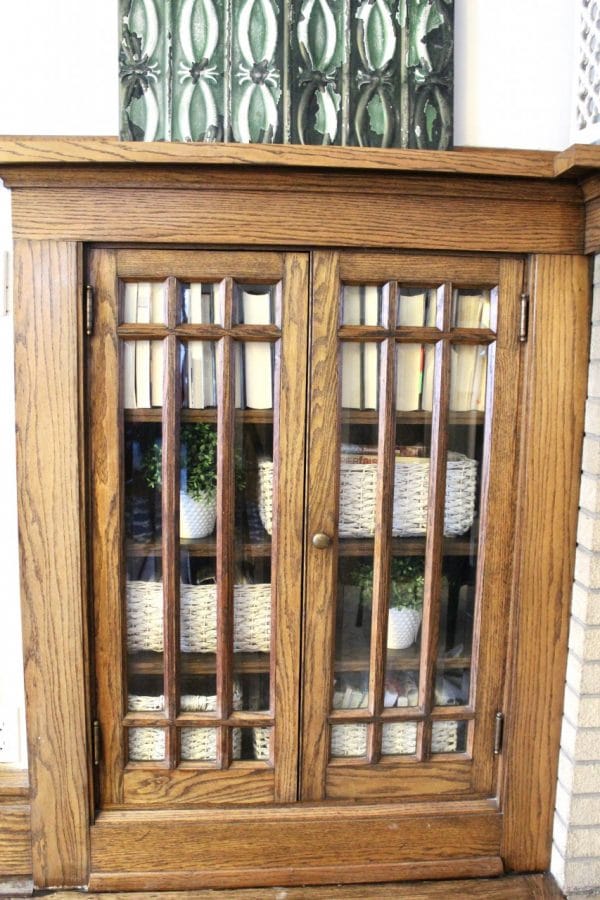 looking through glass doors of built-in with white wicker baskets