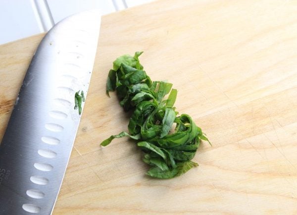 basil leaves rolled then sliced.