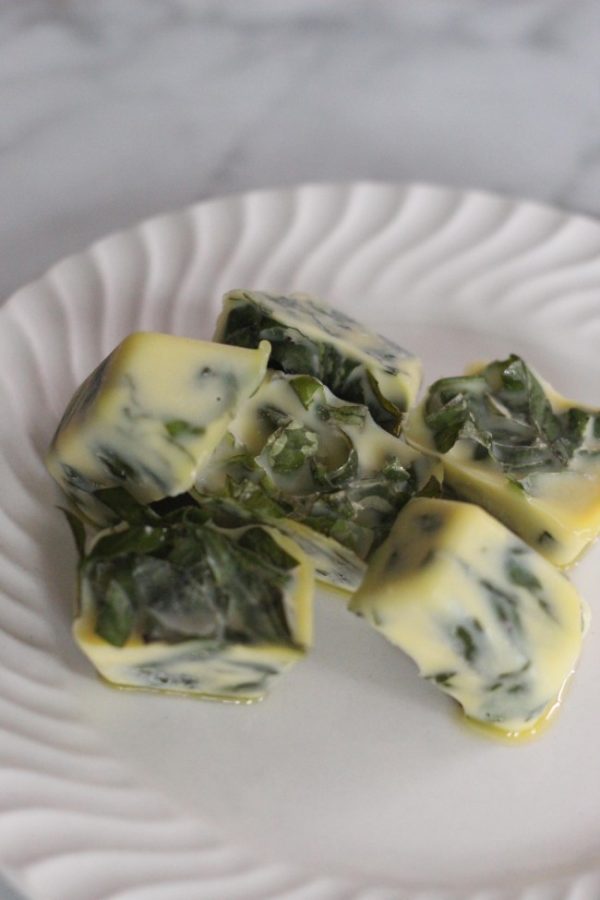 fresh basil in an ice cube tray with olive oil