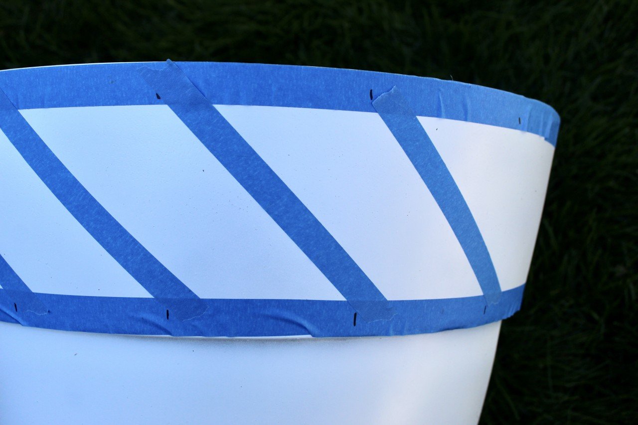 painters tape on white planter with a geometric design