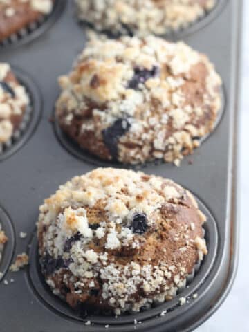closeup of pumpkin blueberry muffins in a muffin tin
