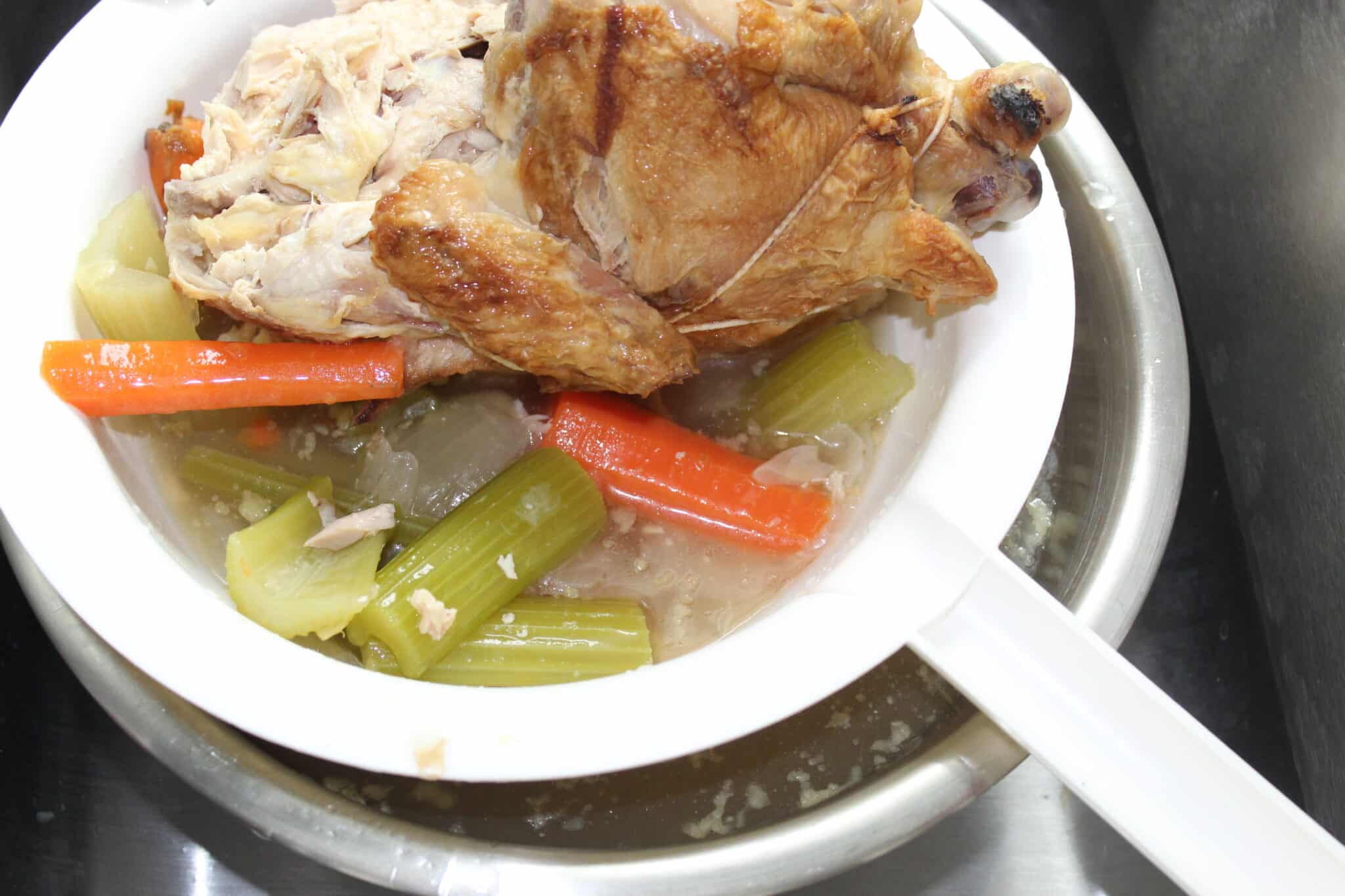 straining chicken soup stock