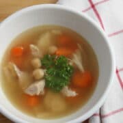 chicken soup with chickpeas garnished with parsley