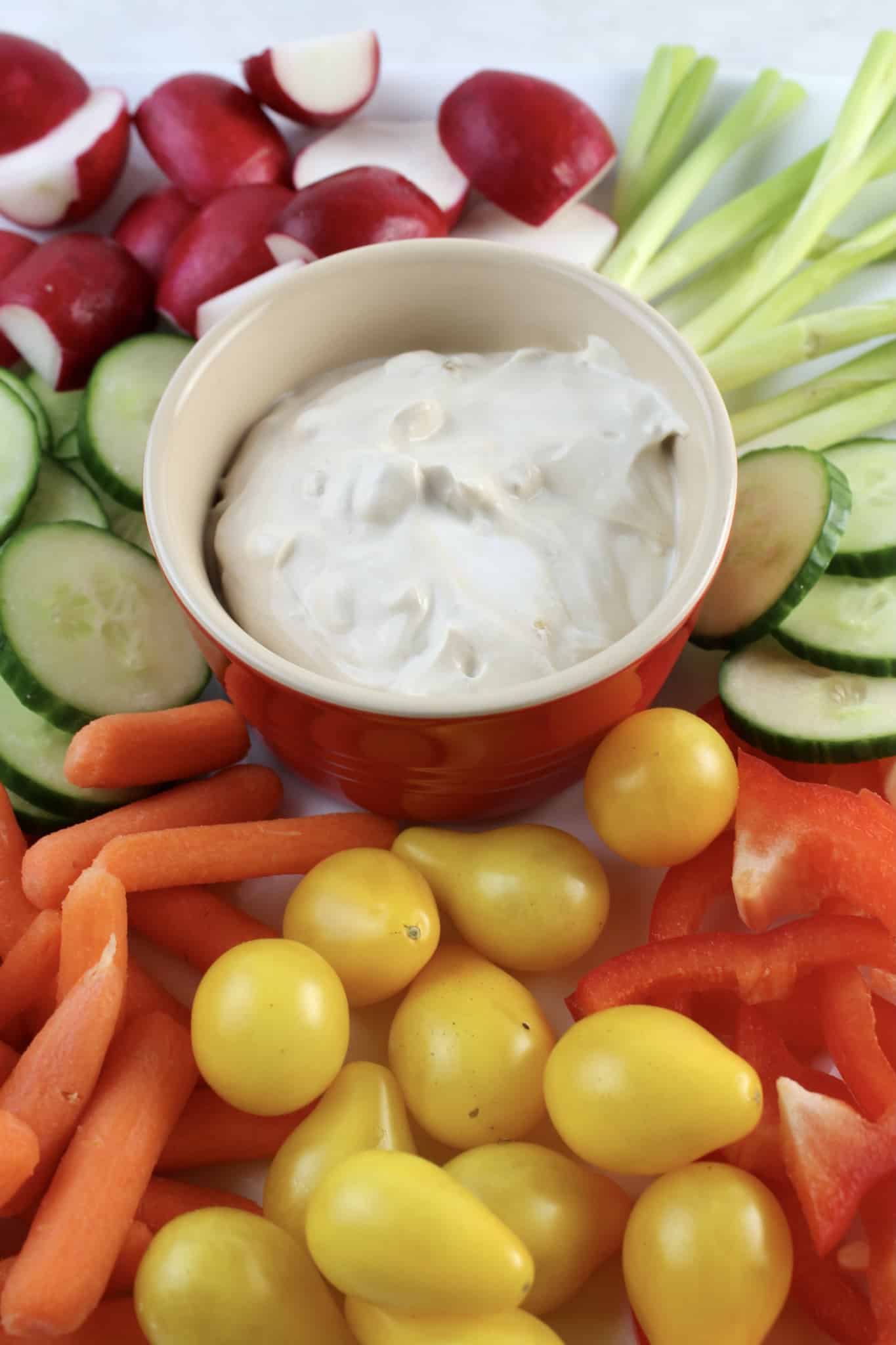 vegetable dip in the center of raw vegetables
