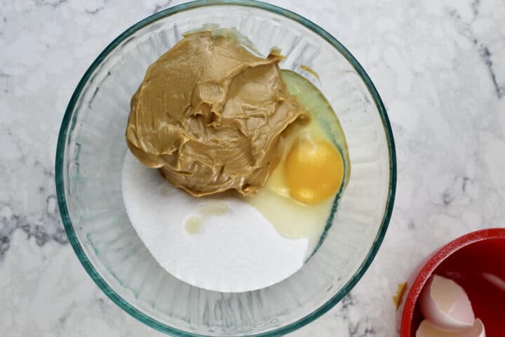 peanut butter, egg and sugar in a clear bowl