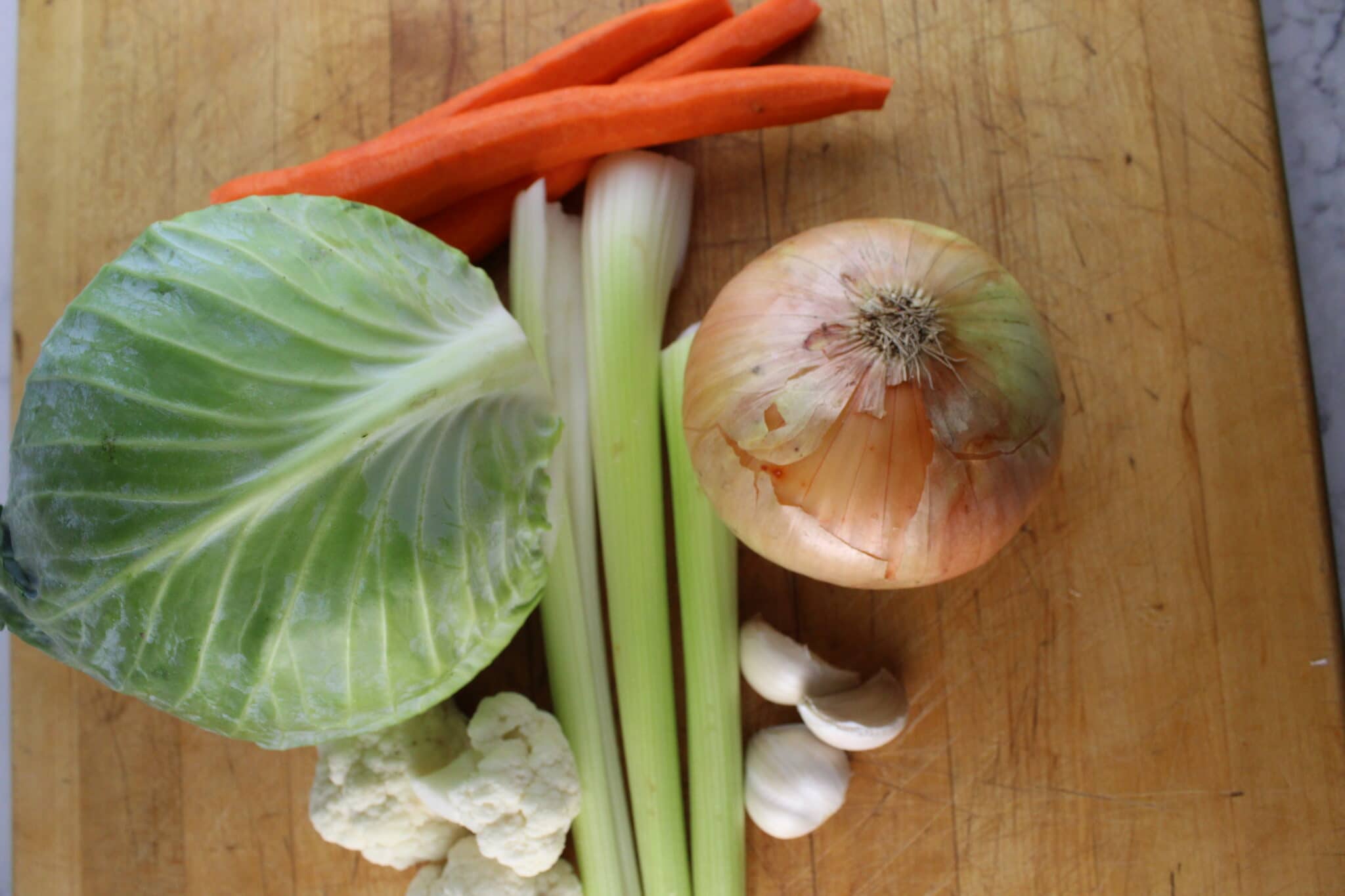 green cabbage, carrots, celery, cauliflower, onion and garlic