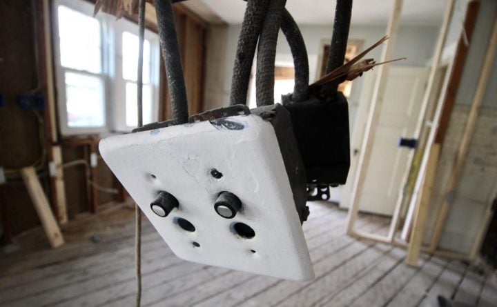 knob and tube wiring with old light switch dangling where the wall was