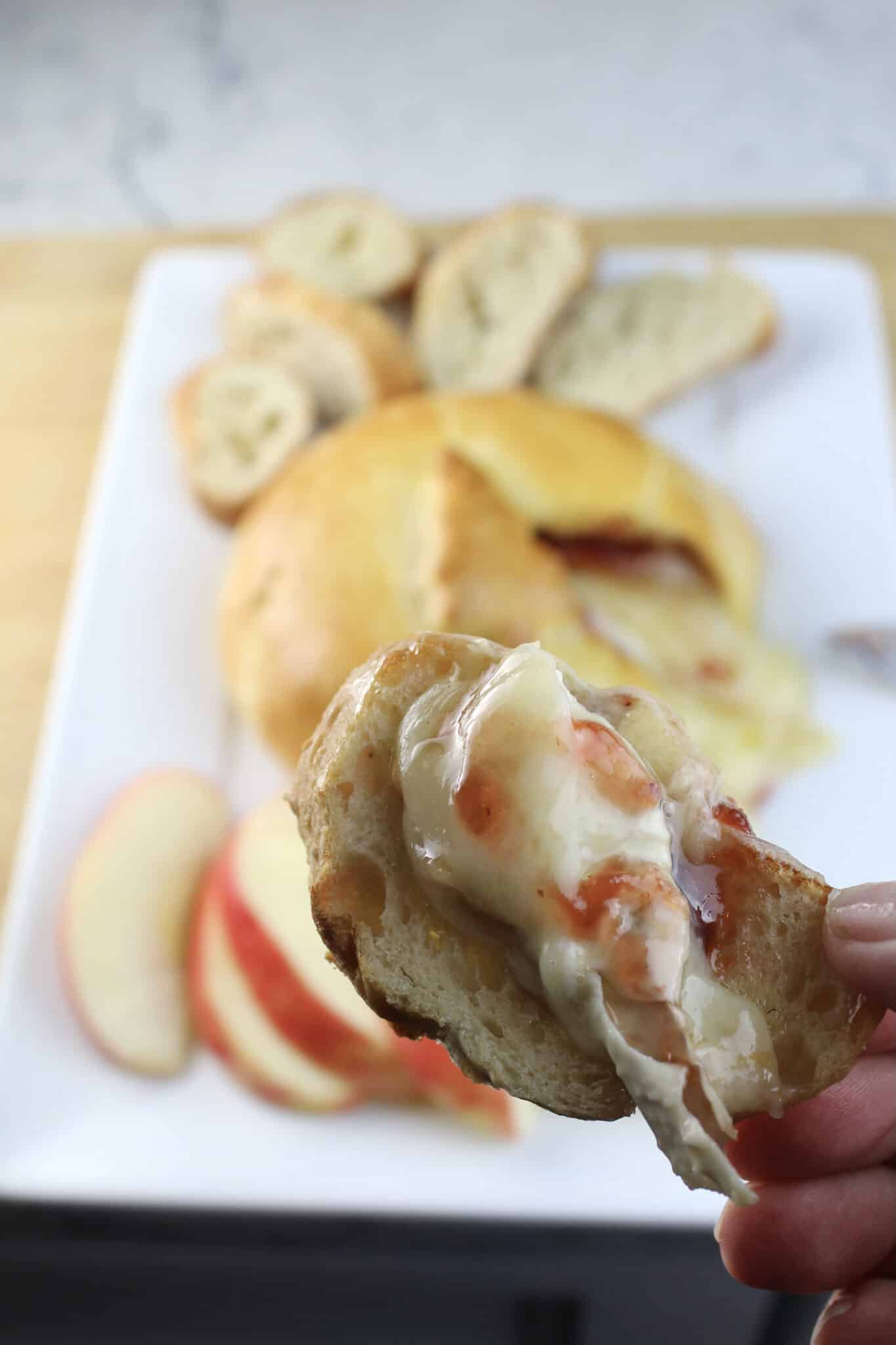 raspberry baked brie on a piece of baguette