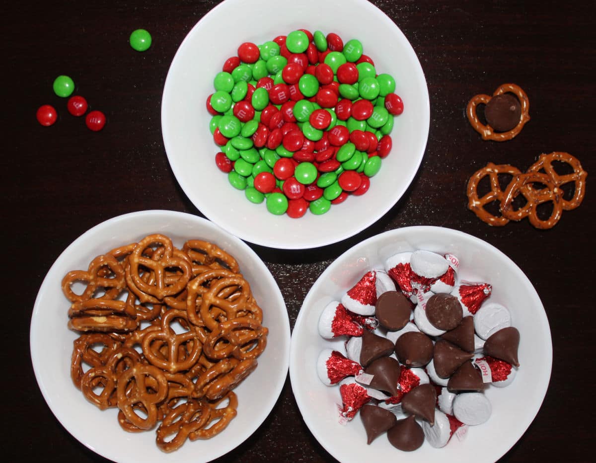 pretzels, unwrapped hershey kisses and red and green m&ms for Christmas