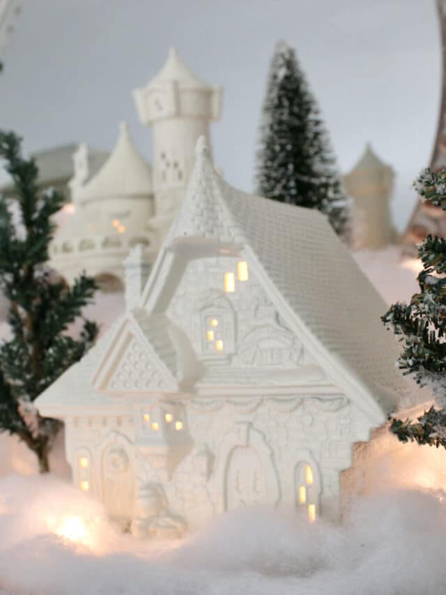 a lit up house in my white Christmas village