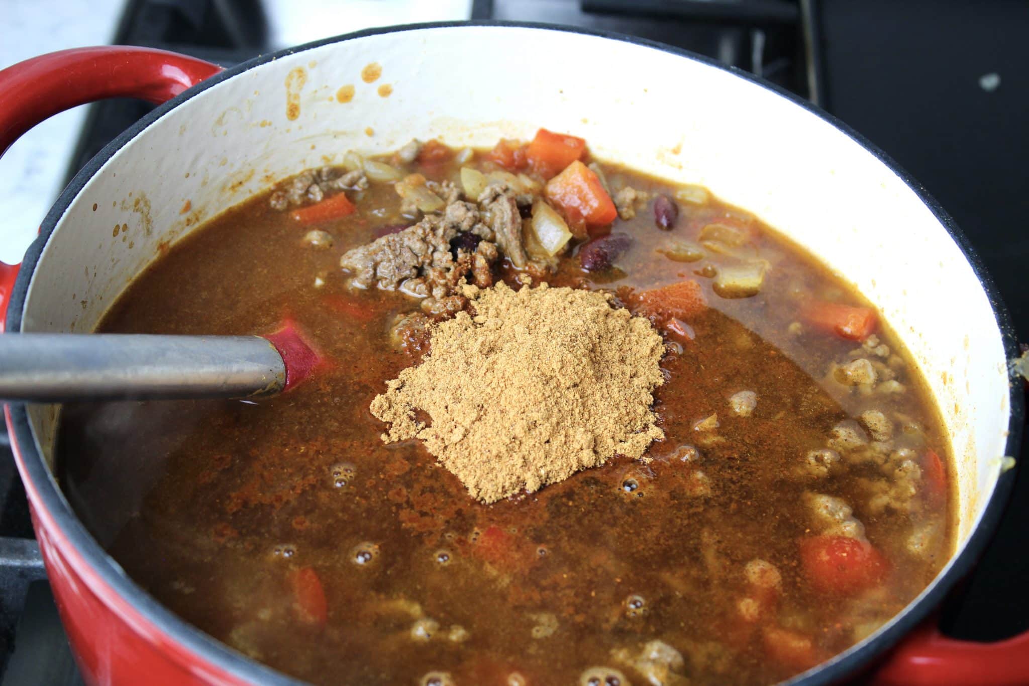 taco seasoning being added to dutch oven