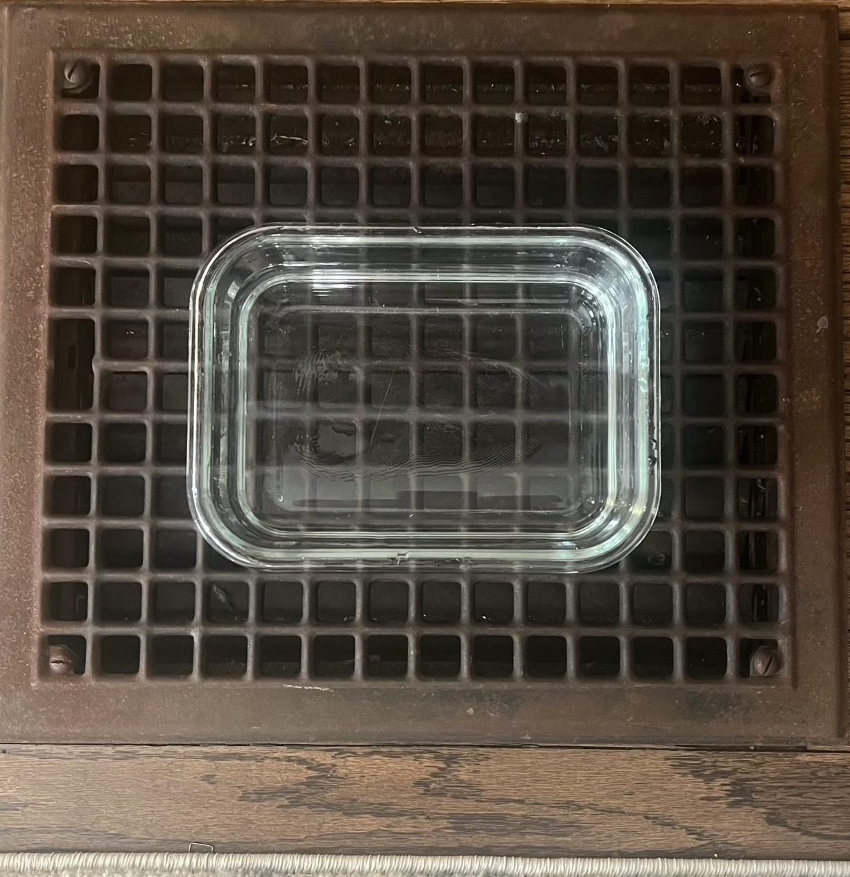 water in container on floor grate