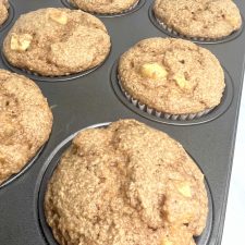 a dozen apple spice muffins in a muffin tin