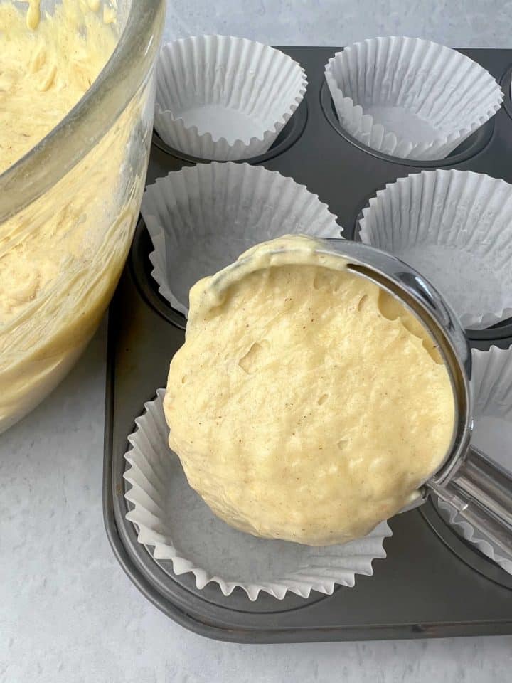 scooping the dough into the muffin pan