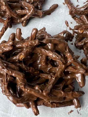 Chocolate covered chowmain noodles in piles on a baking sheet