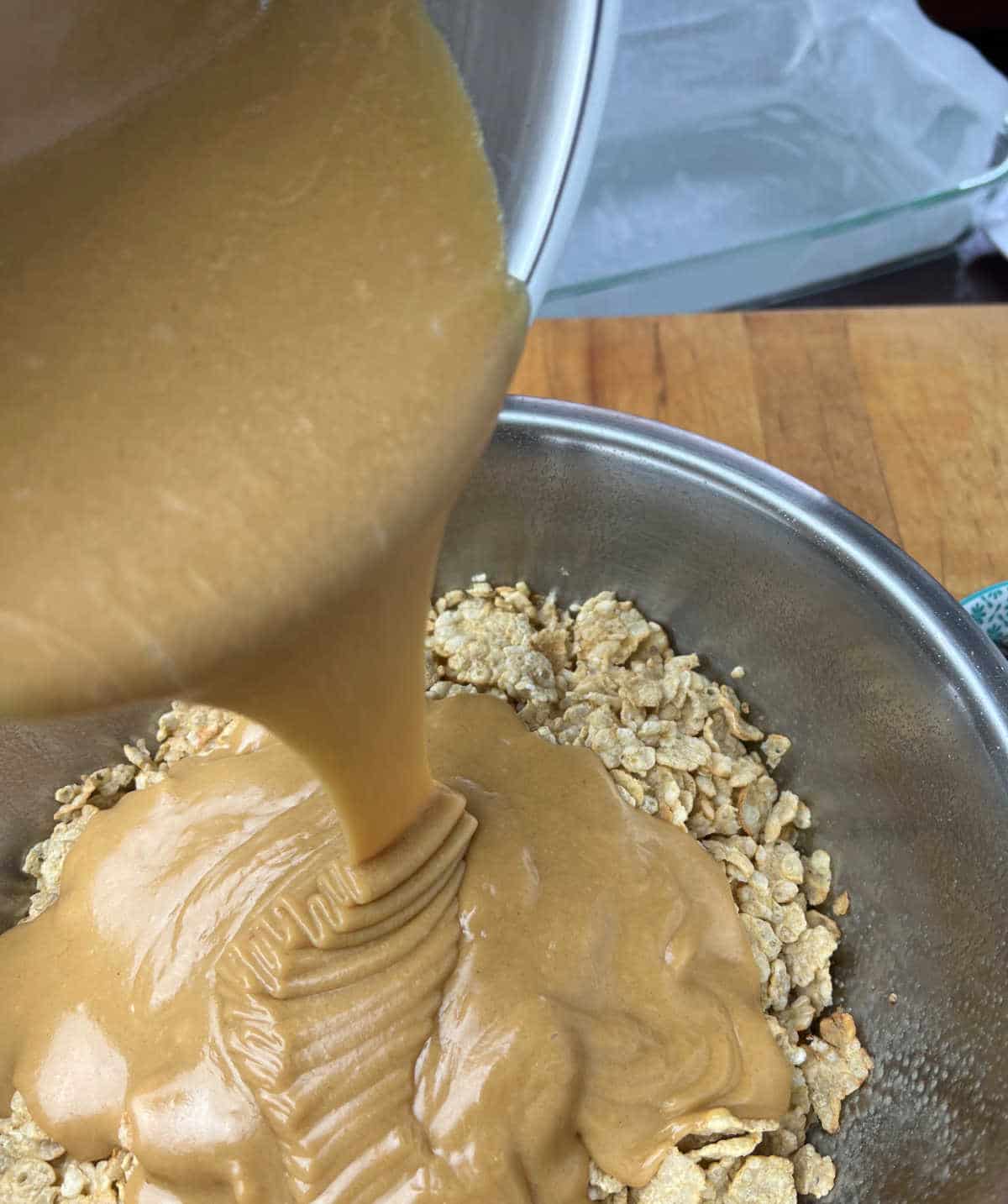 pouring peanut butter mixture onto Special K cereal