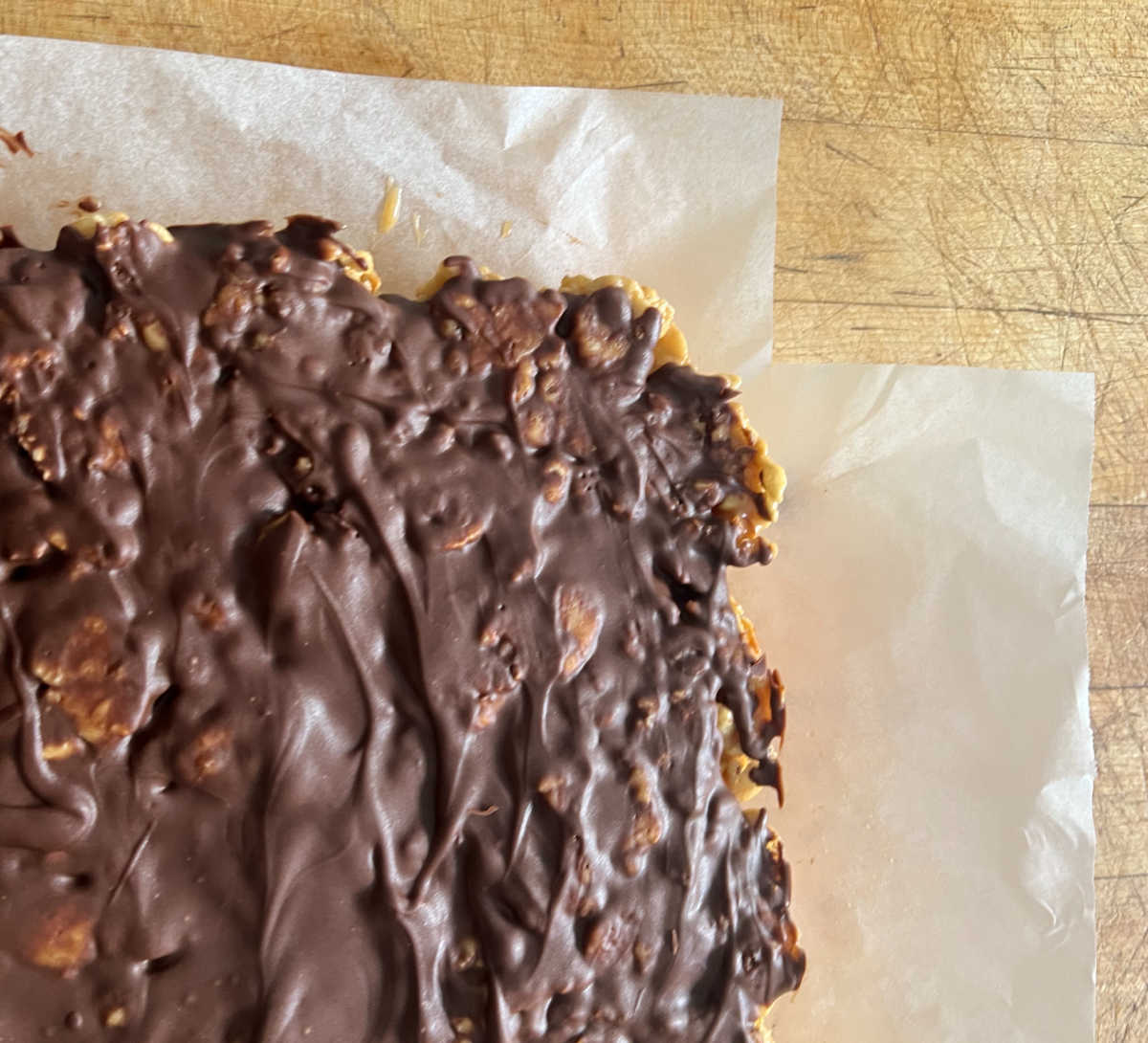 Special K bars prior to cutting on parchment paper.