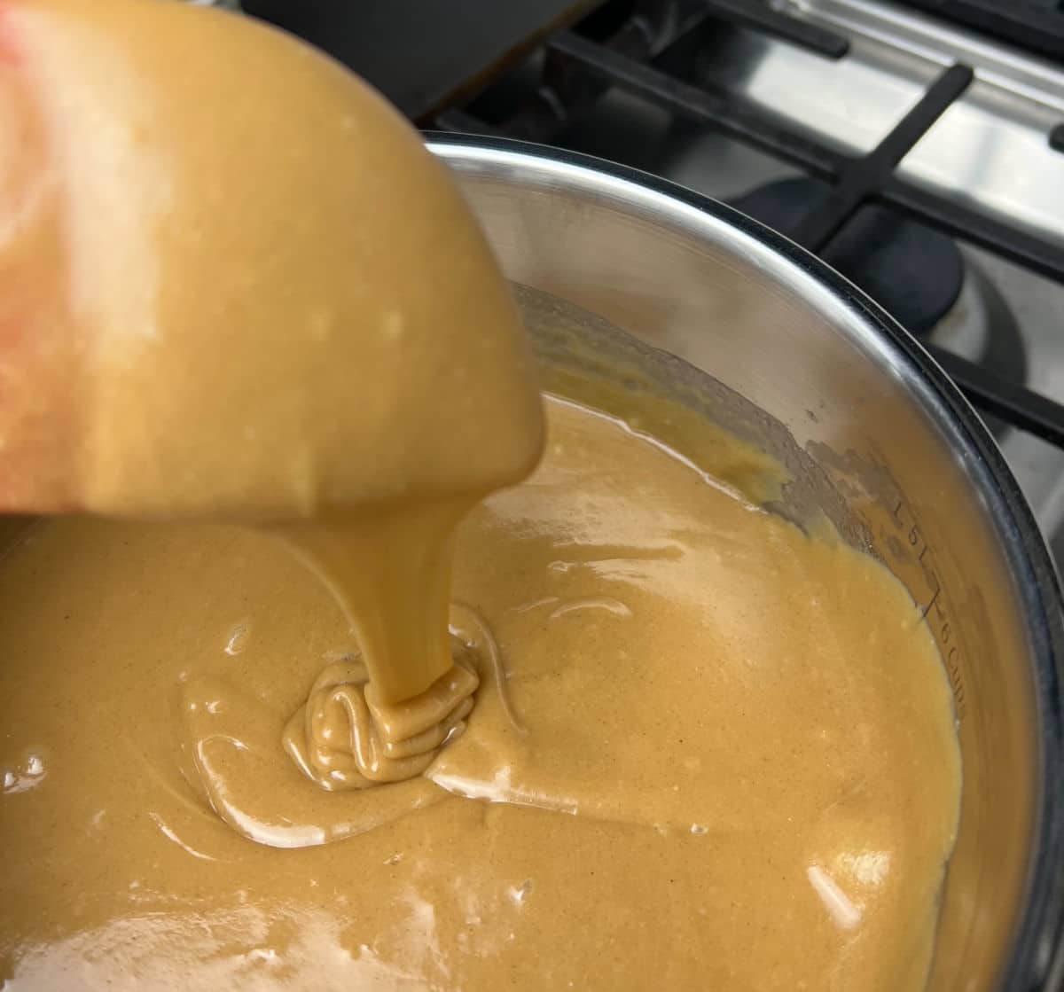 peanut butter and sugar mixture running off a spoon