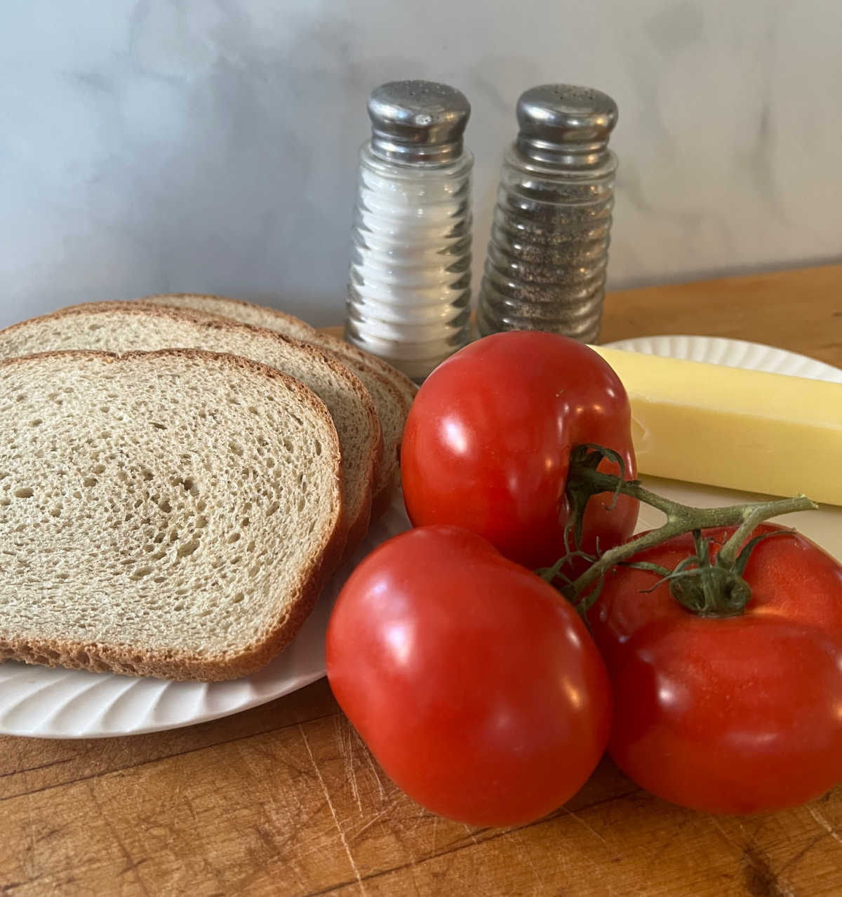 fresh tomatos, rye bread, butter, salt and pepper