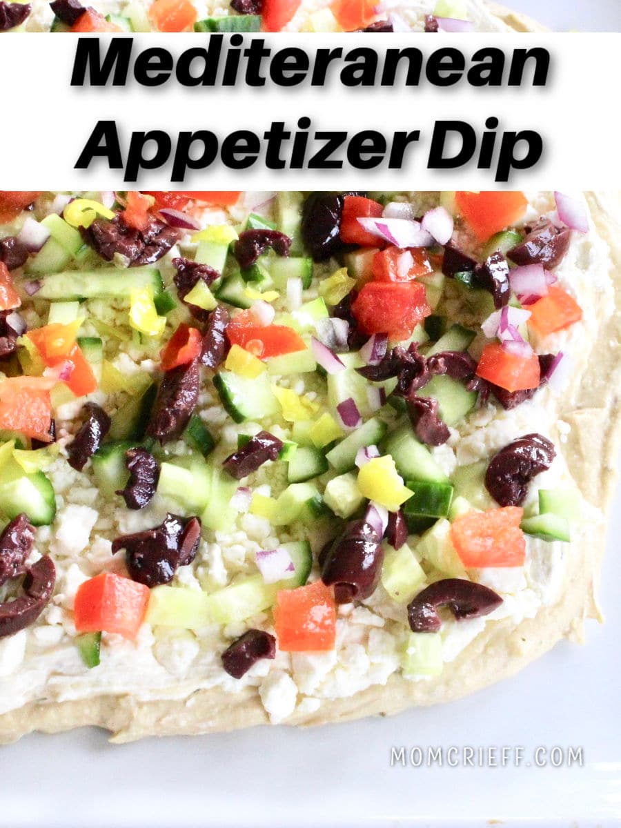 greek appetizer with layers of hummus, cheese spread, feta, chopped cucumber, tomato, red onion and feta