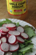 sliced radishes on a bed of lettuce