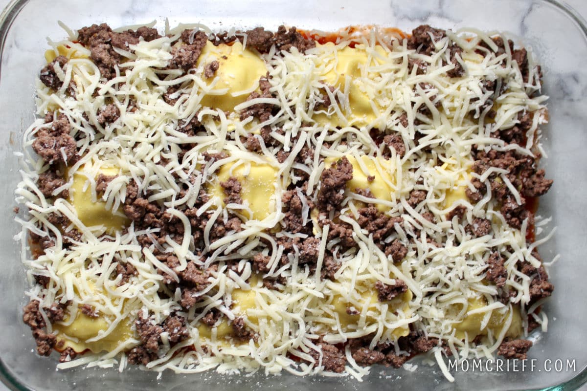 beef and shredded cheese on top of ravioli