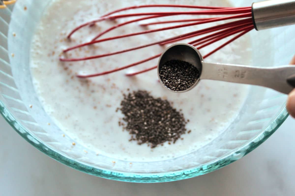 adding chia seeds to steel overnight oats mixture.