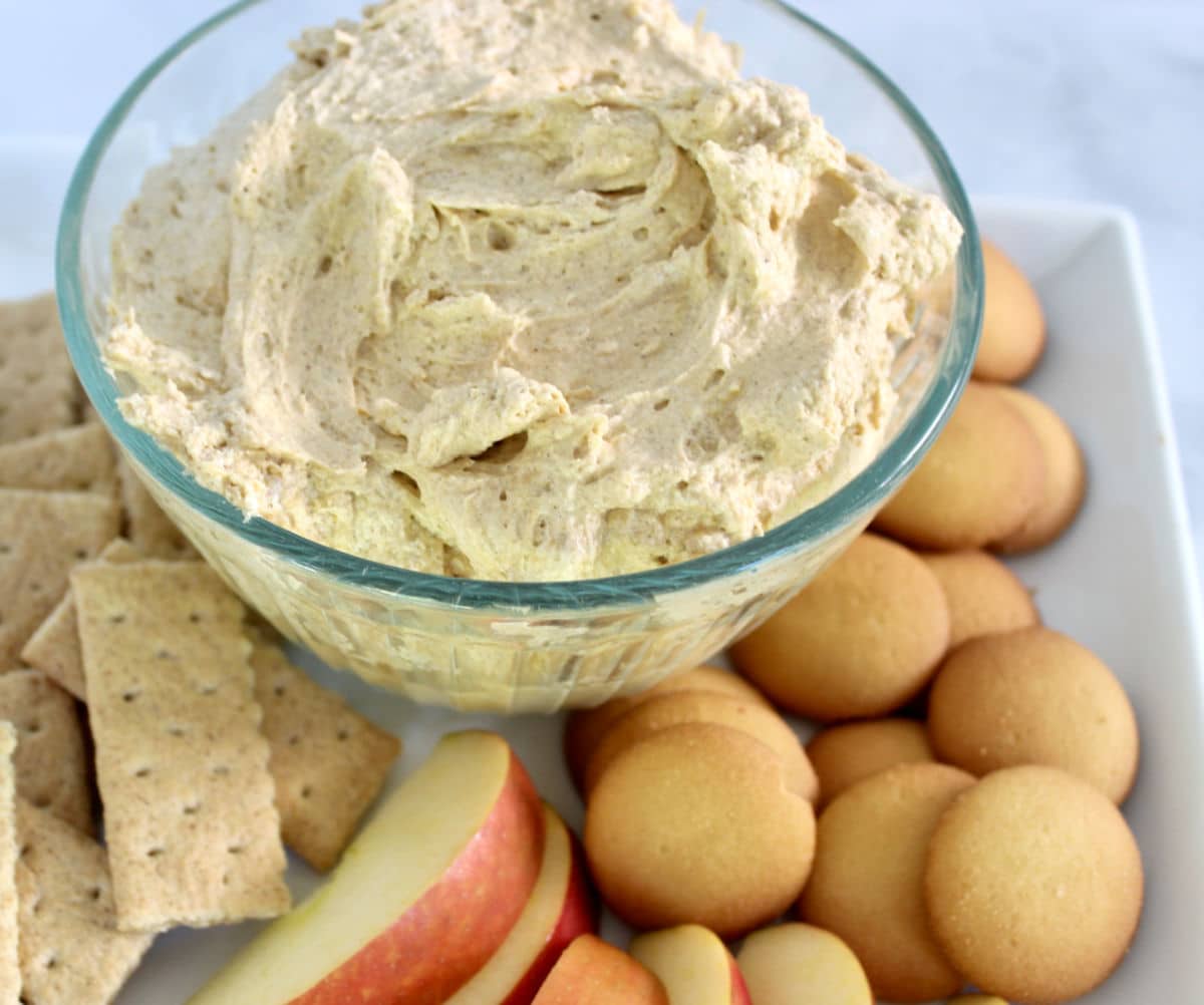 pumpkin dip on a tray with apples and graham crackers