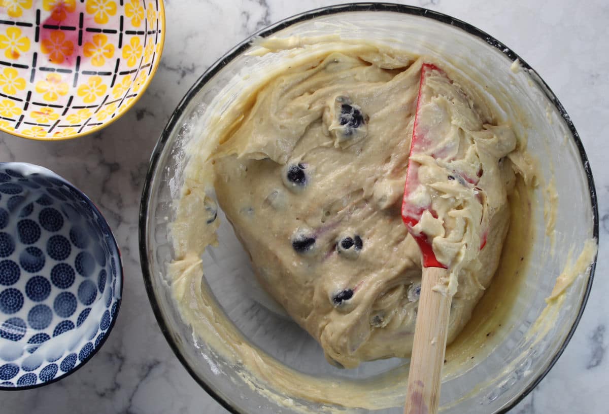 folding together ingredients for blueberry yogurt muffins.