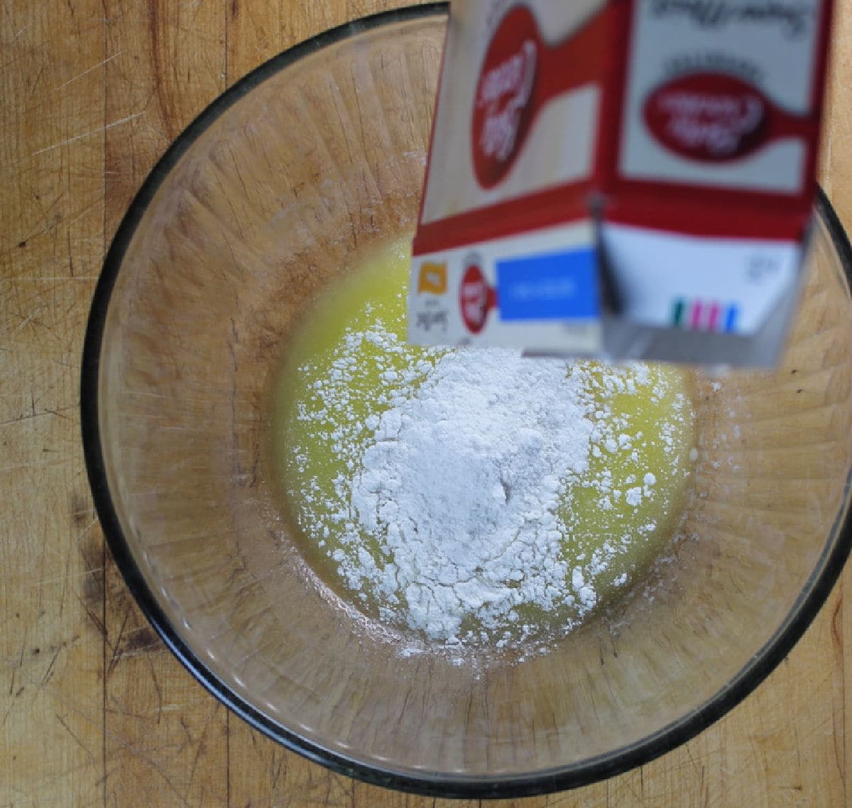 pouring cake mix into melted butter