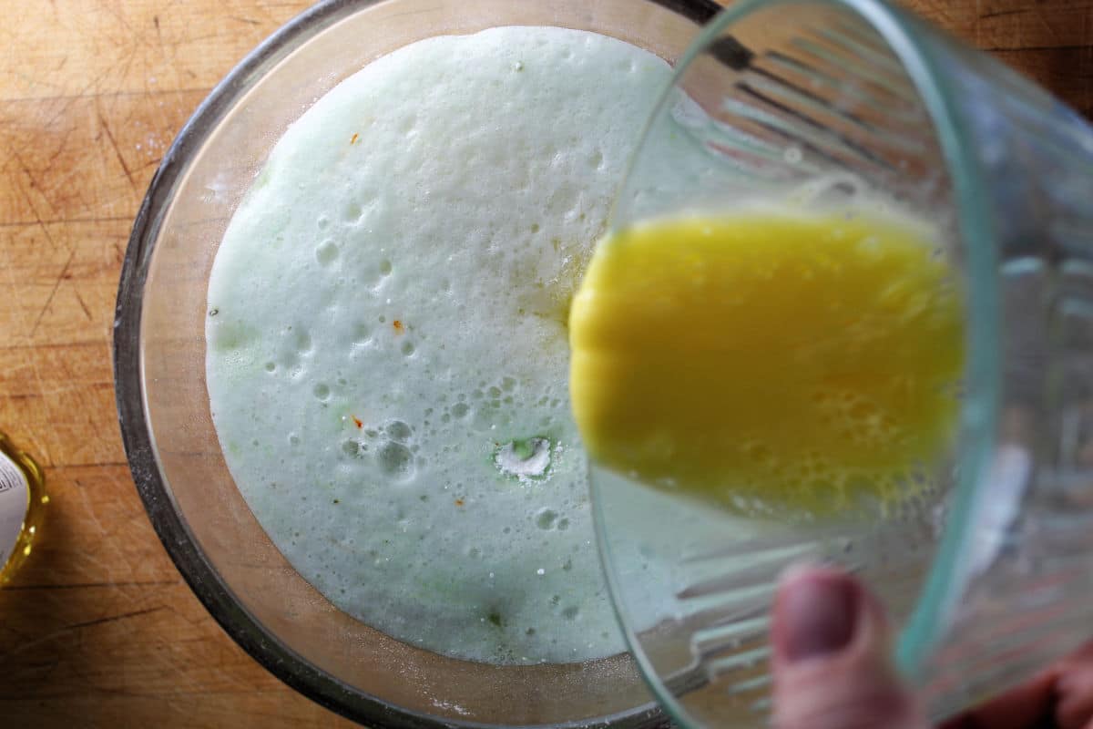 adding eggs to pistachio bundt cake batter
