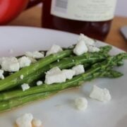 asparagus topped with balsamic vinegar and feta cheese.