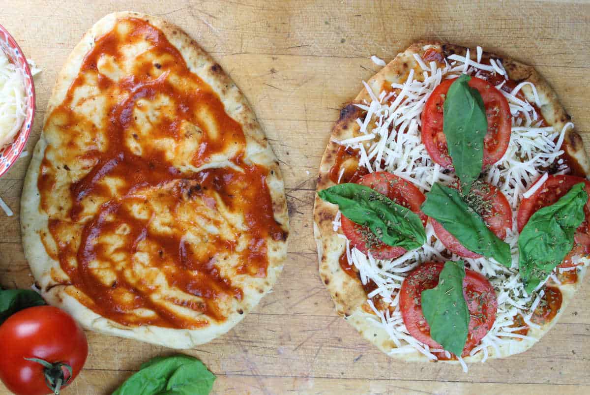 assembling naan pizza
