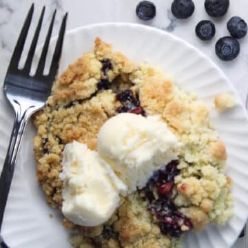serving of blueberry cobbler with vanilla ice cream.