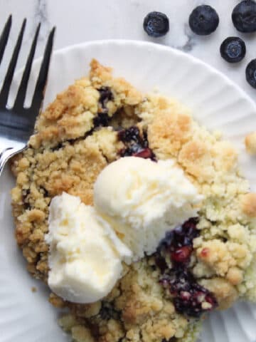 serving of blueberry cobbler with vanilla ice cream.