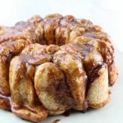 monkey bread with caramel sauce sitting on a white plate