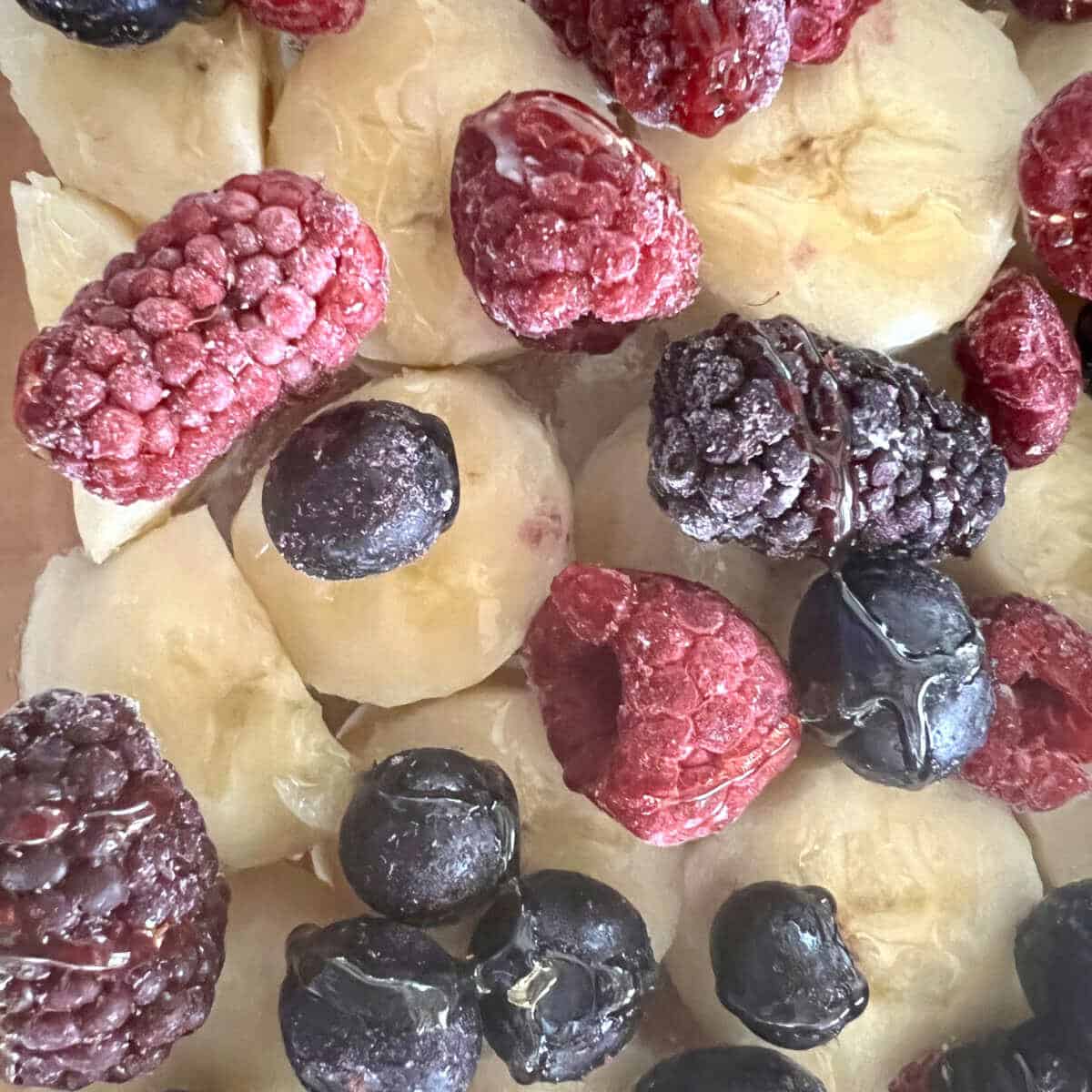 frozen berries on sliced bananas