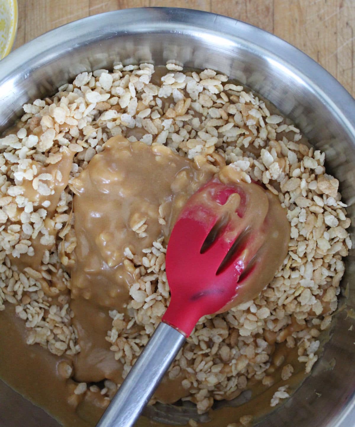 stirring melted chocolate and butterscotch chips into rice krispie cereal.
