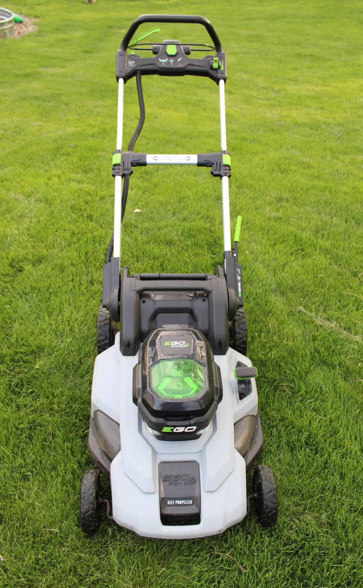 an EGO battery operated lawnmower on the grass.