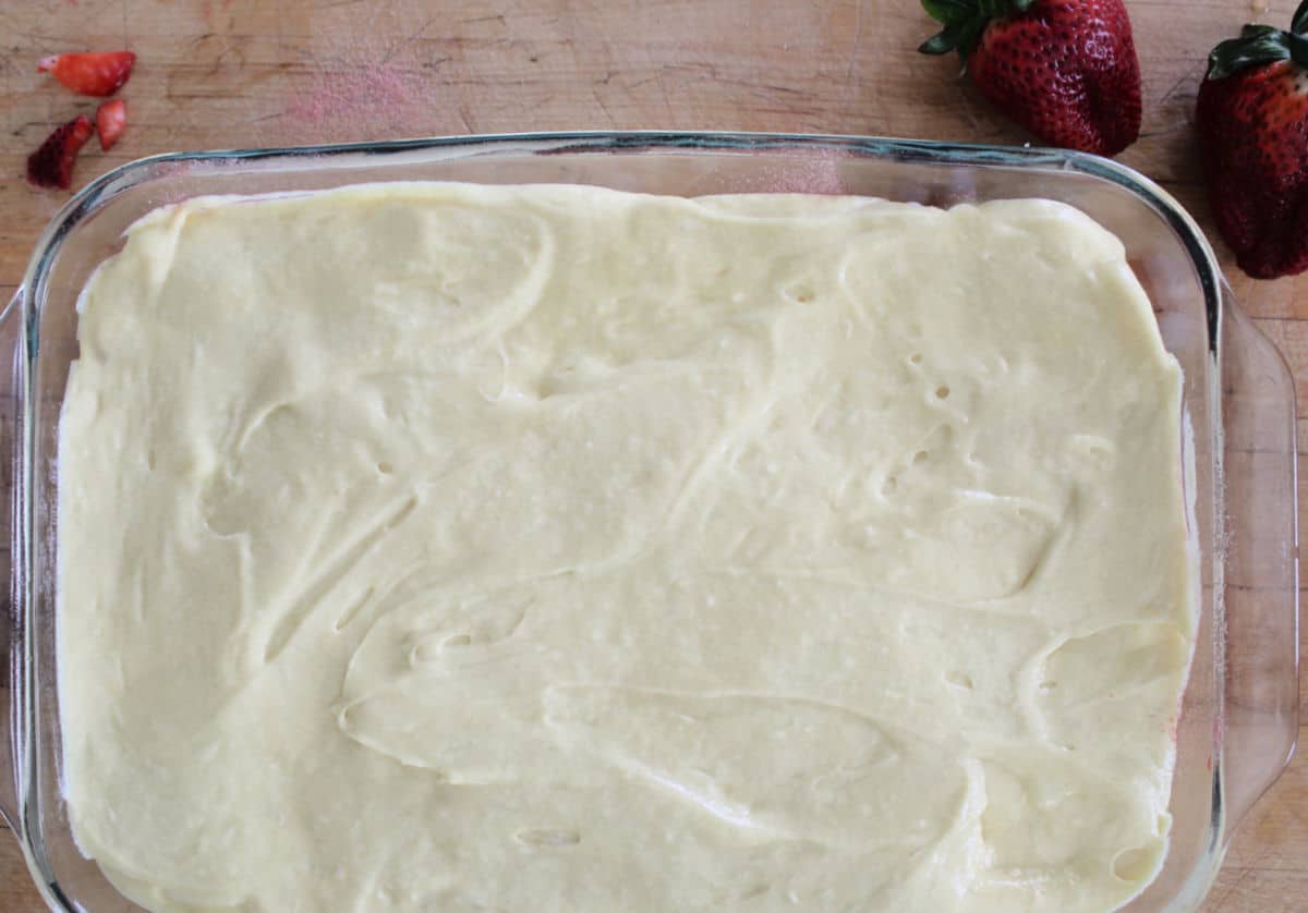 cake batter covering strawberries.