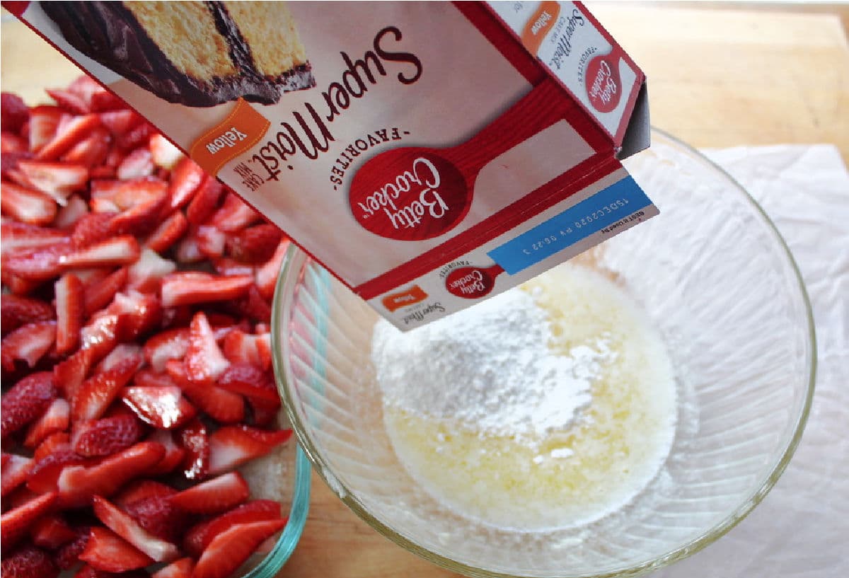 mixing cake mix into melted butter for three ingredient dump cake