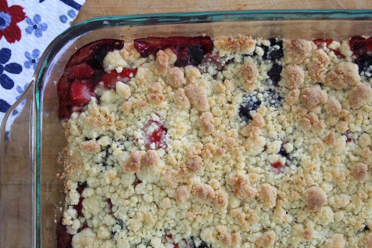 baked berry cobbler in a glass baking dish.