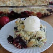 a serving of berry cobbler with a scoop of ice cream on top.