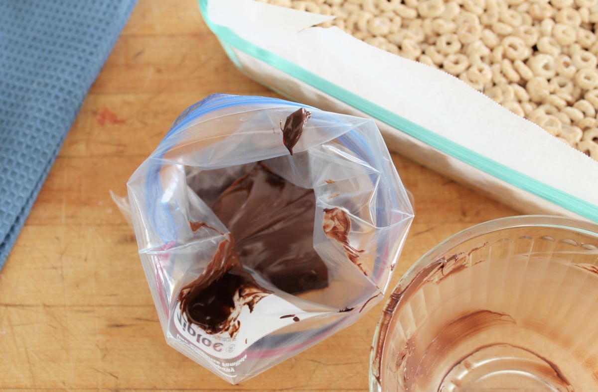 A filled plastic bag to be used to drizzle chocolate over cereal bars. 