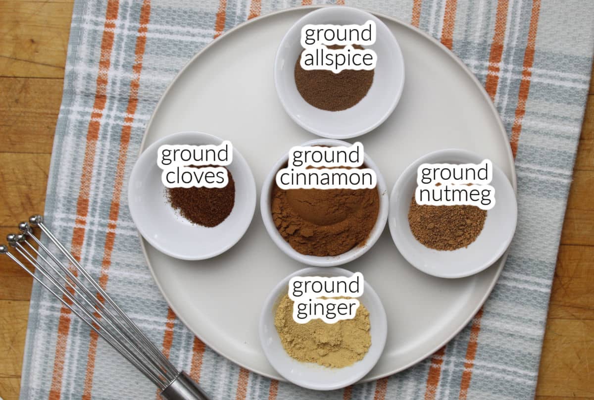 ground cinnamon, ginger, nutmeg, allspice and cloves in small individual containers.