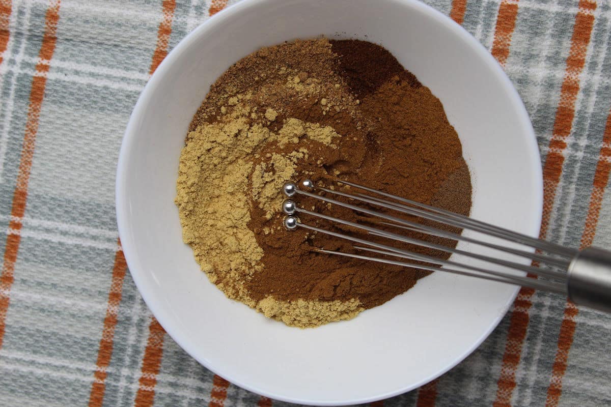 mixing spices to make pumpkin spice mix.