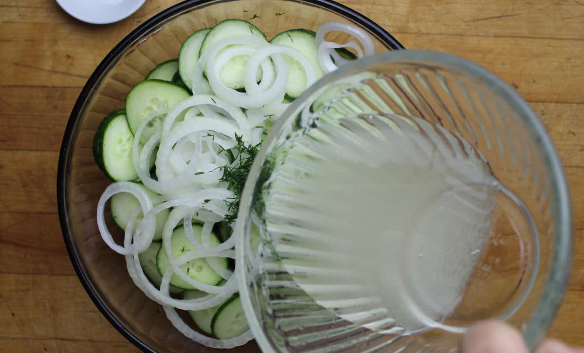 Vinegar and sugar mixture poured on top of sliced cucumbers and onions.